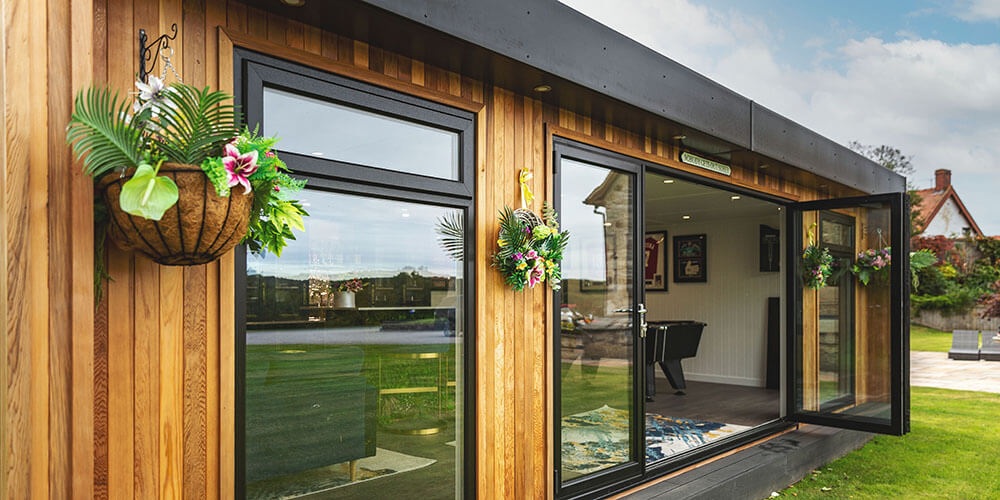 Looking across a large luxury garden bar with open bifold doors