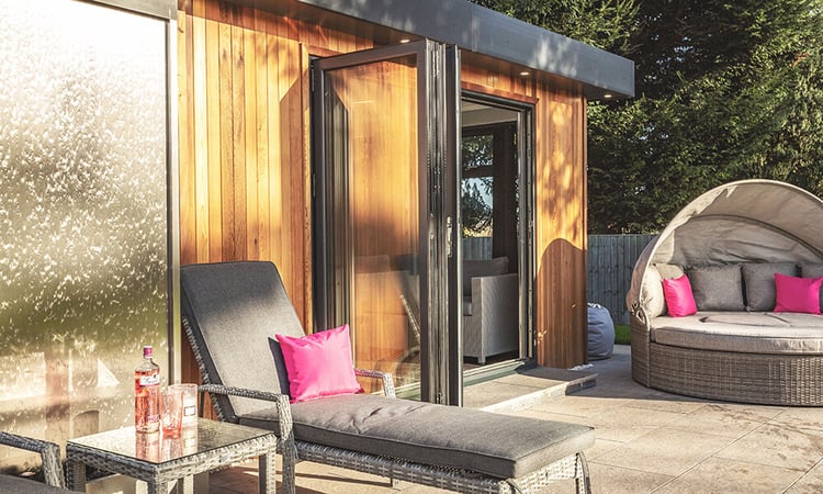 Garden summerhouse in cedar cladding with outdoor seating