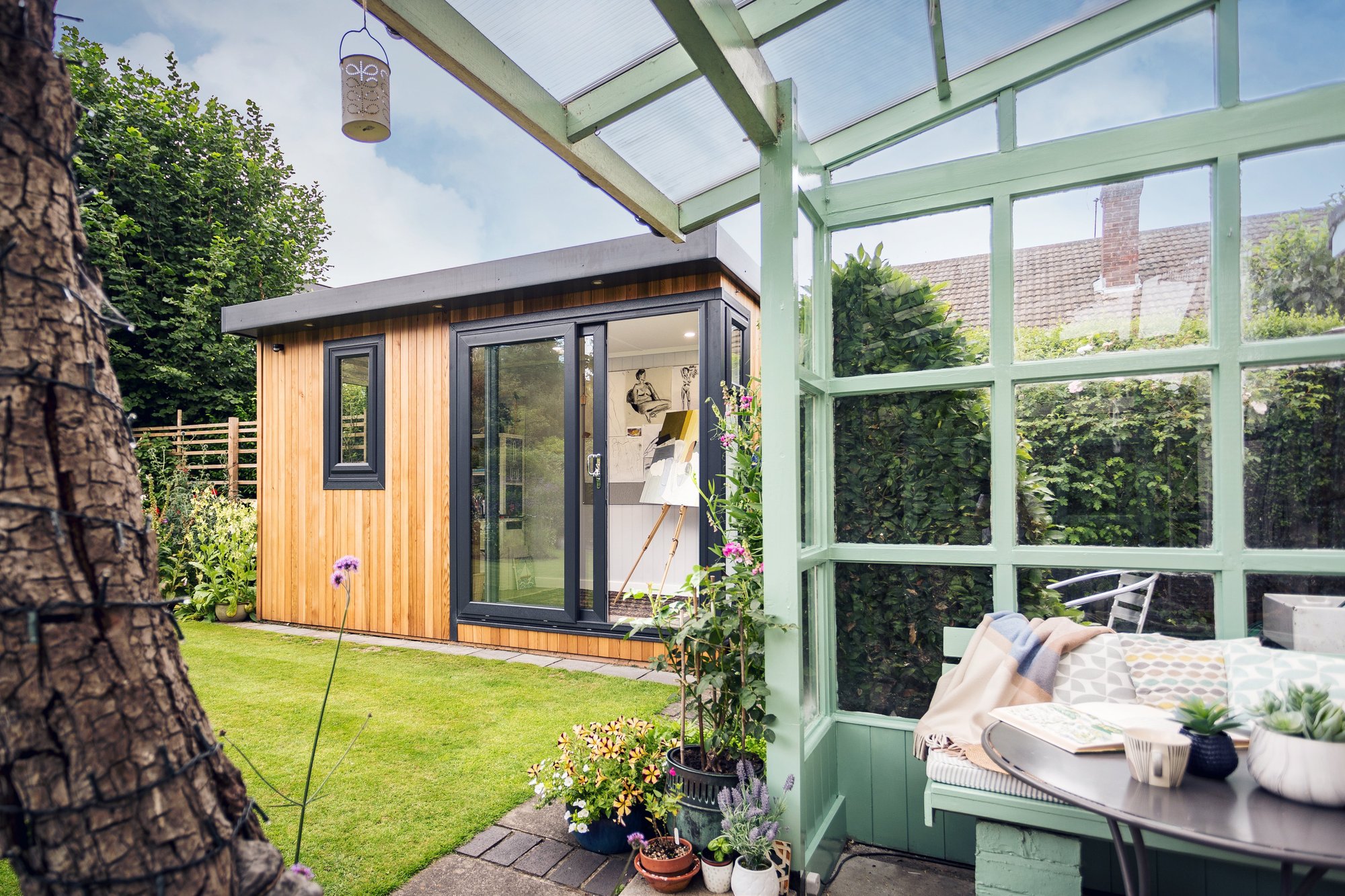 Small Garden Room with green trellis and potted plants next to it with open sliding glass doors 
