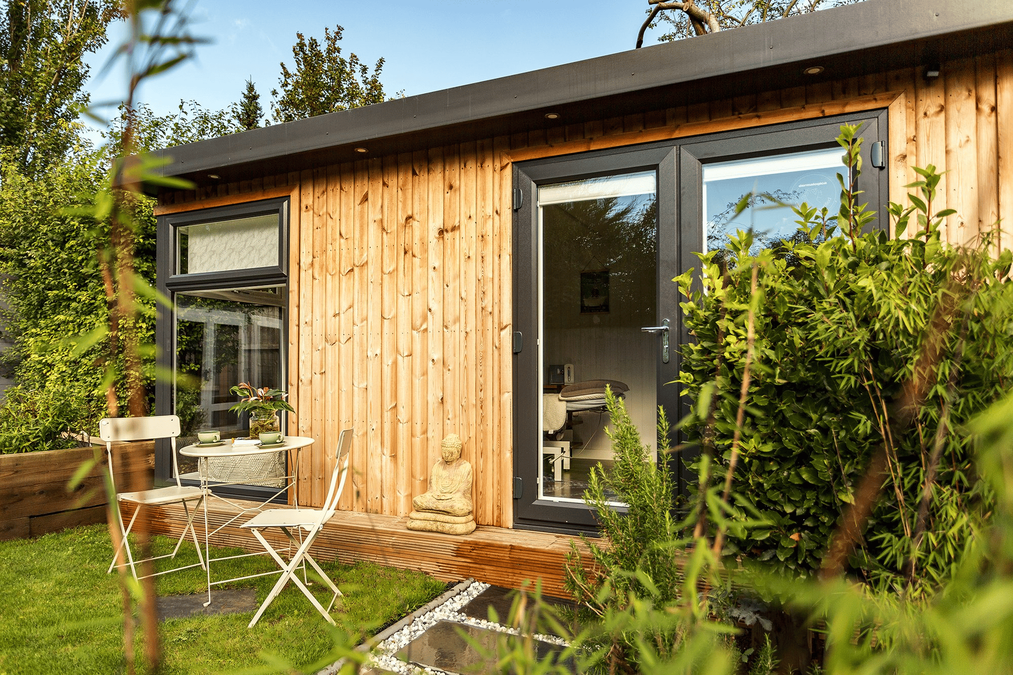 Redwood Beauty Room Garden Building with lawn area in front and table and chairs 