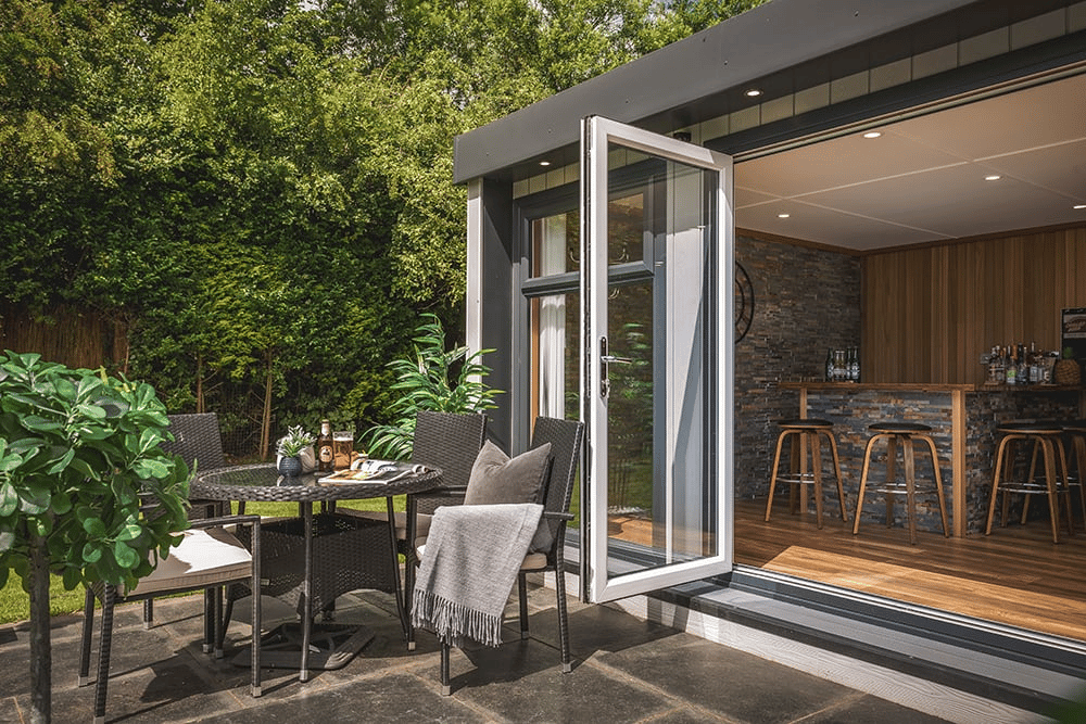 Garden Room with Bi-fold Doors and rattan furniture on patio area