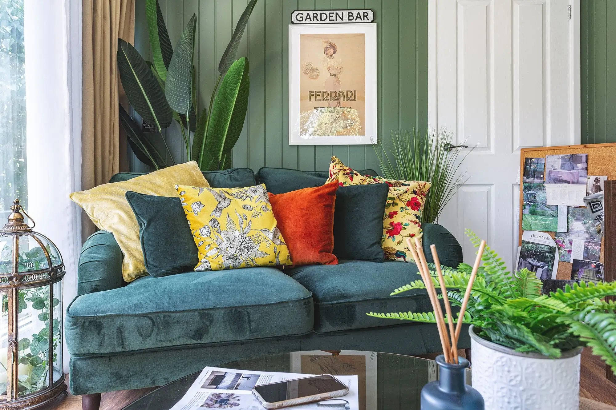 large cedar garden room with velvet green sofa and patterned cushions