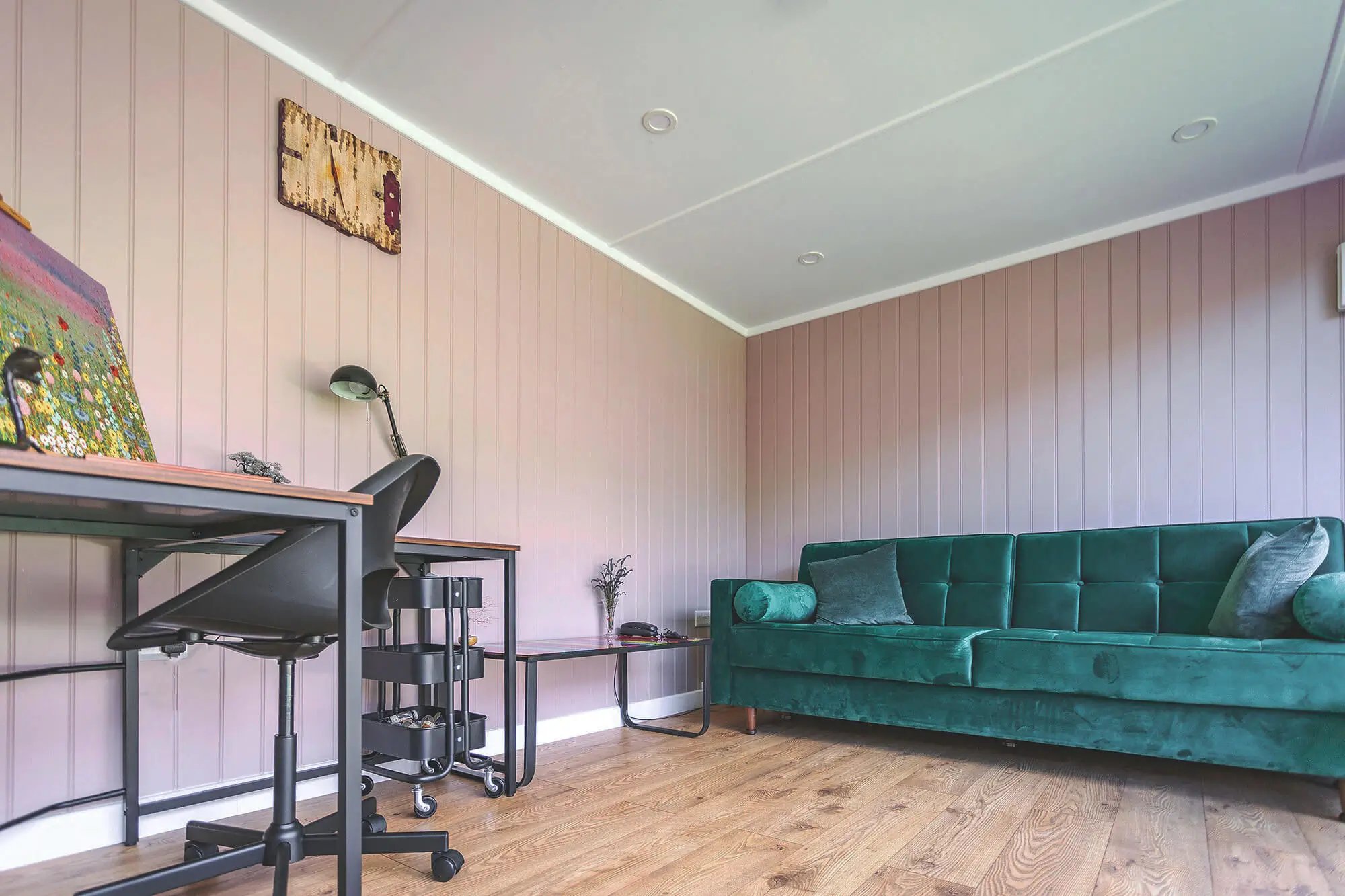 Garden Room with hair coloured walls and green velvet sofa and office furnishings and hardwood floors 