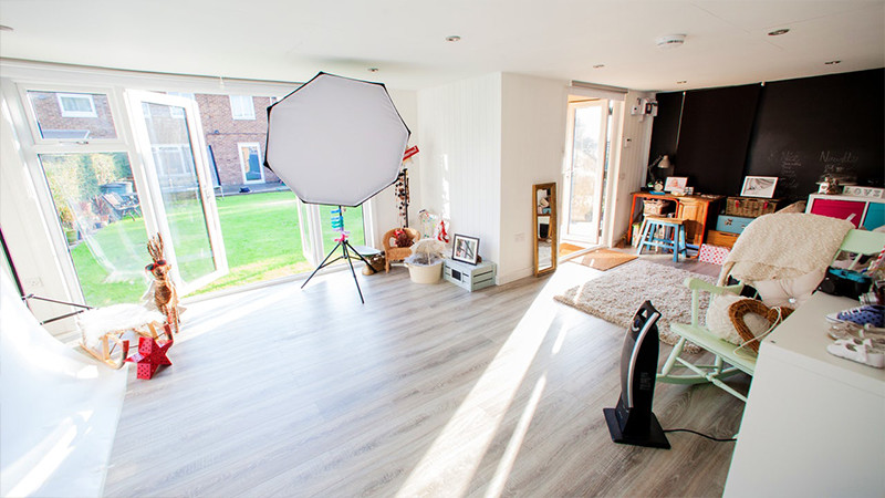 Interior of a Photography Studio in Garden with lighting, umbrellas and props