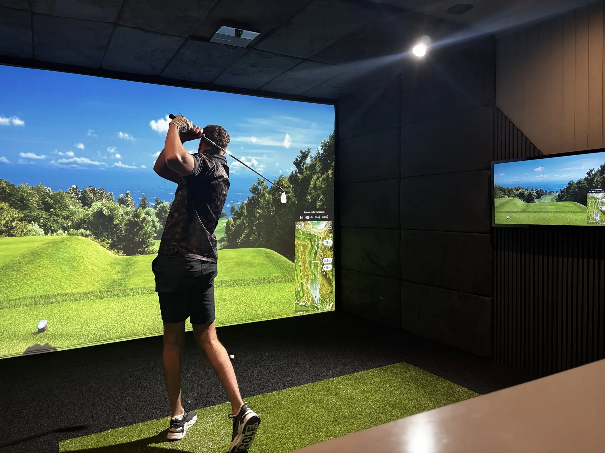 golf enthusiast using a golf simulator