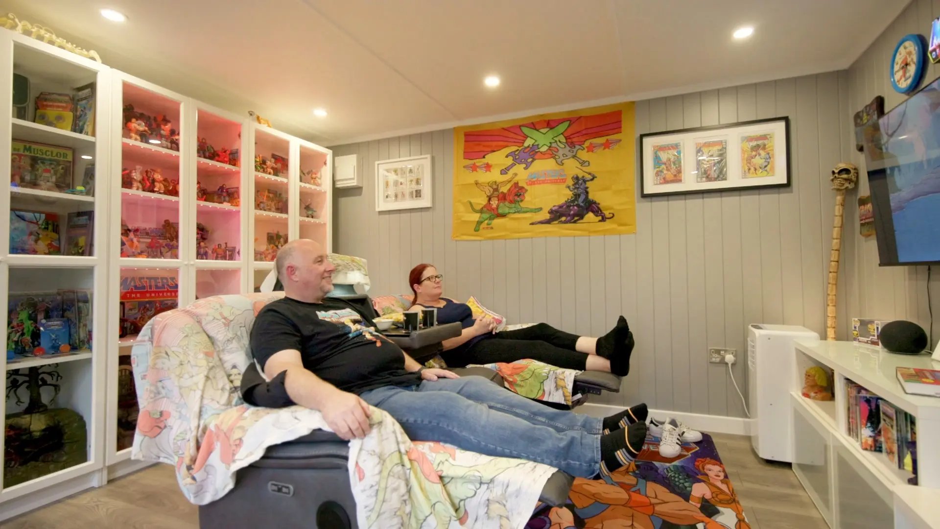 man and woman enjoying a garden room where they collect he man collectibles 