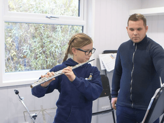 Music room studio pupil practising with teacher