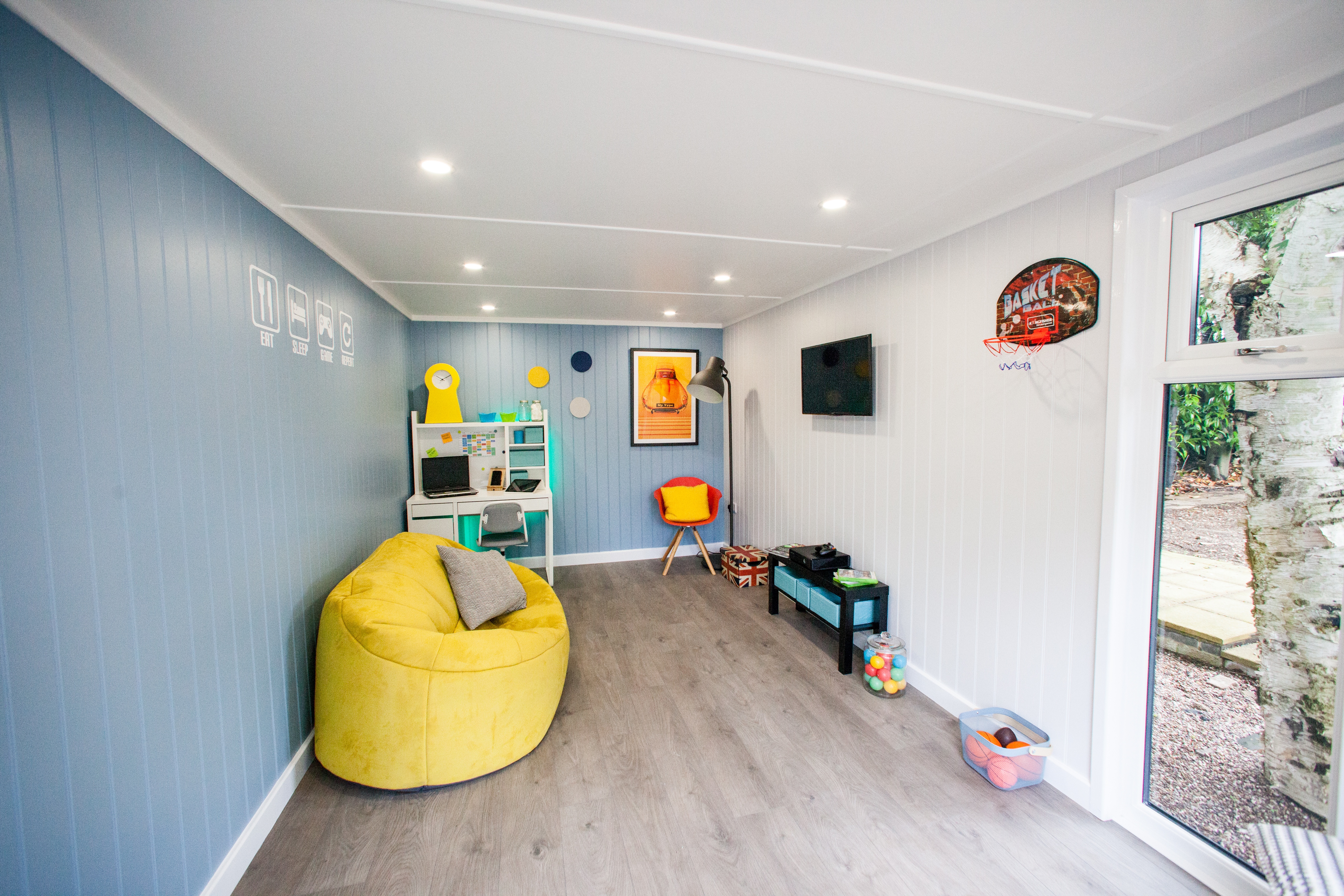 Interior of a Teen Den for Gaming with desk and bean bags