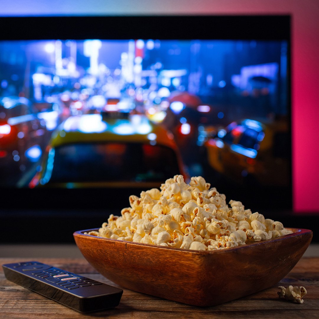 Image of popcorm and big screen TV in a garden cinema room