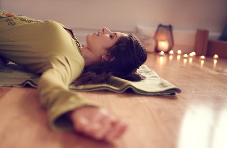 Attractive mixed race woman doing restorative yoga