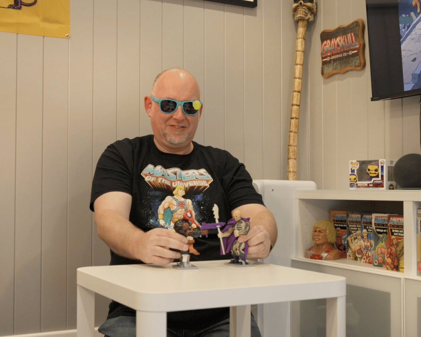 Man playing with He-Man collectable action figures