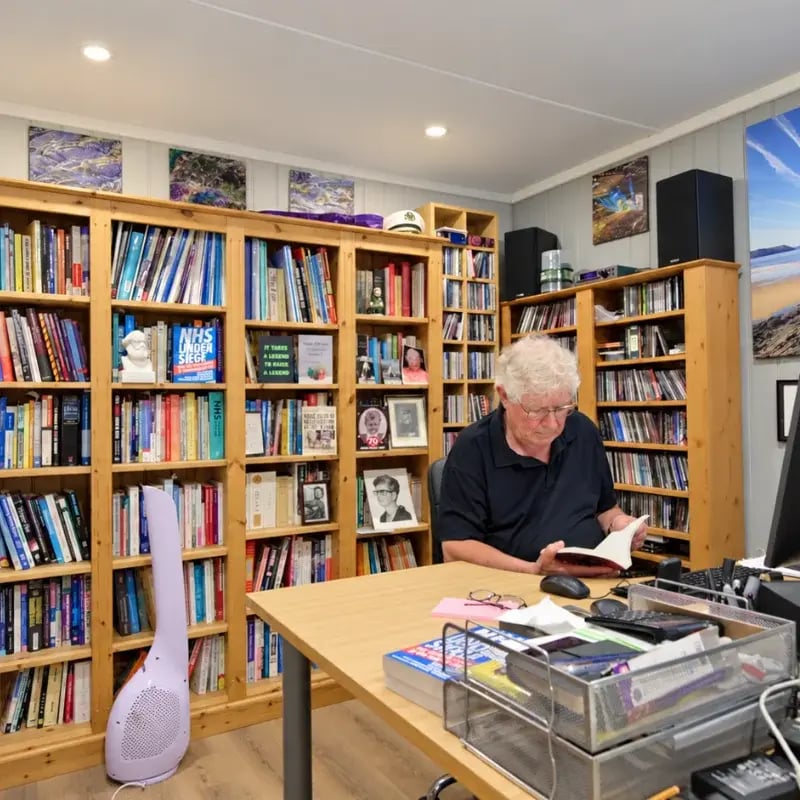 man reading in his garden hobby room