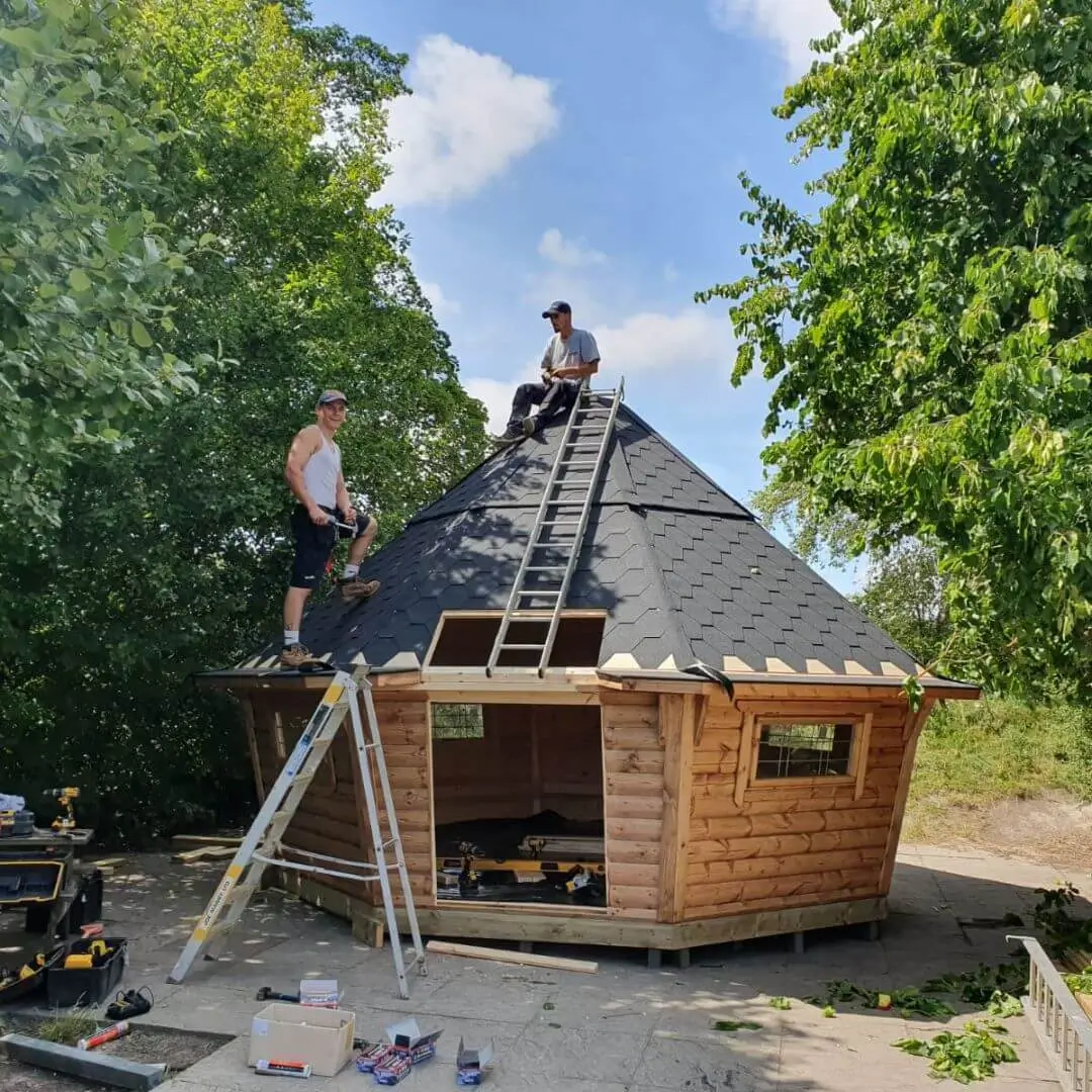 Cabins For Schools black roof building with builders and fitters and ladders and trees in playground area with building tools