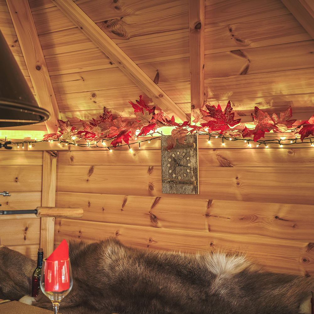 detail of autumn fairy lights inside a grill cabin