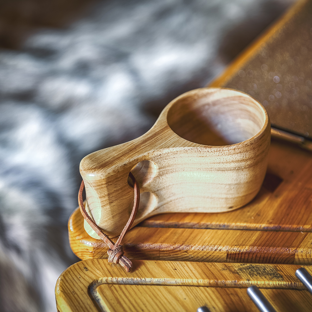 Close up of kuksa mug on tray table next to bbq unit
