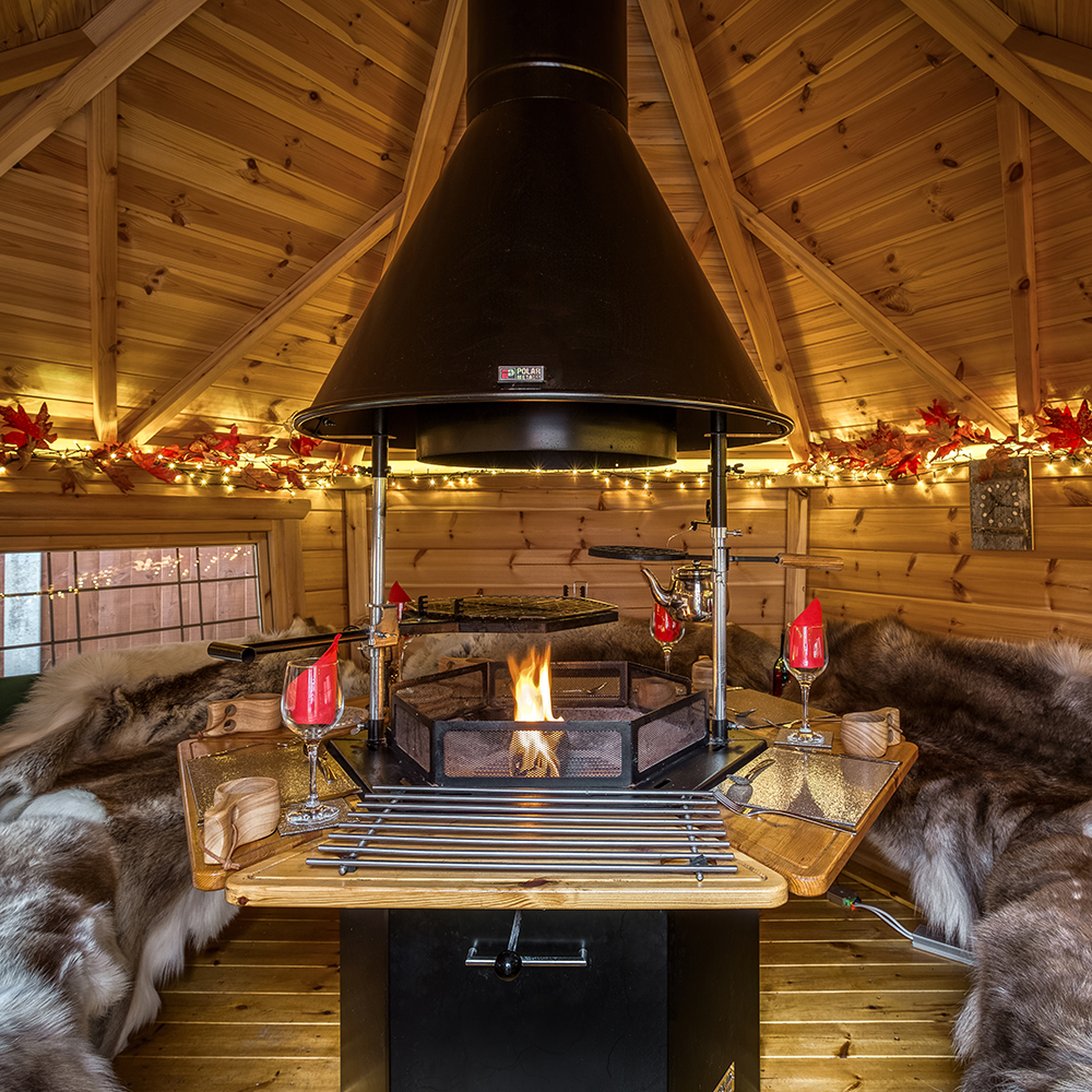 Interior of a small bbq cabin with fire lit & autumnal lighting