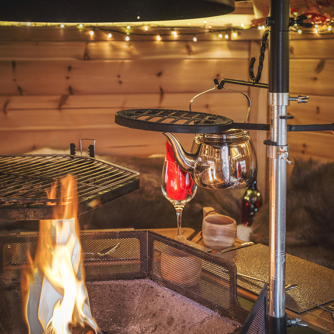 Interior a BBQ hut with fire lit & wine glasseson table
