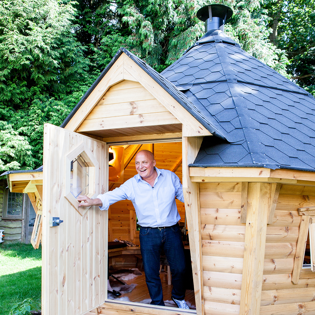 Aldo Zilli coming out of his Arctic BBQ Cabin smiling