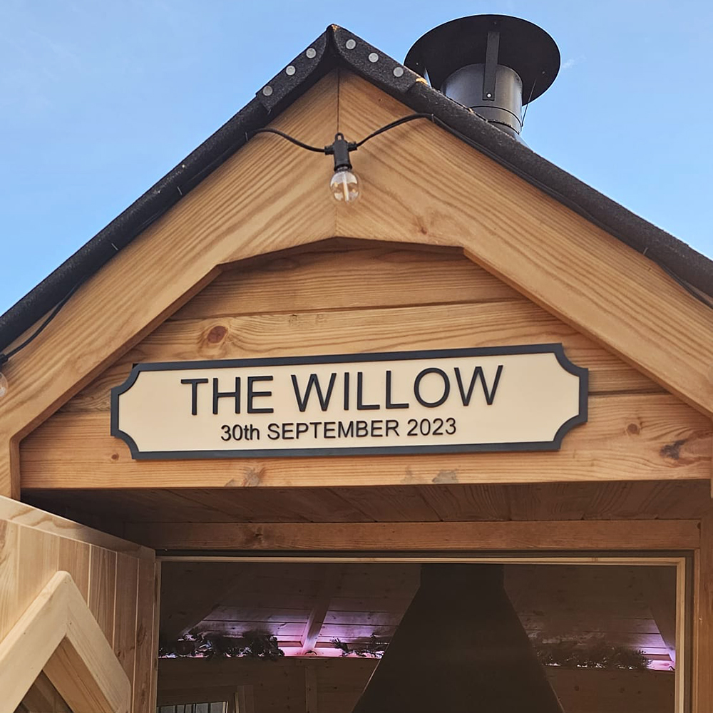 Close up of BBQ hut apex with 'The Willow' sign outside