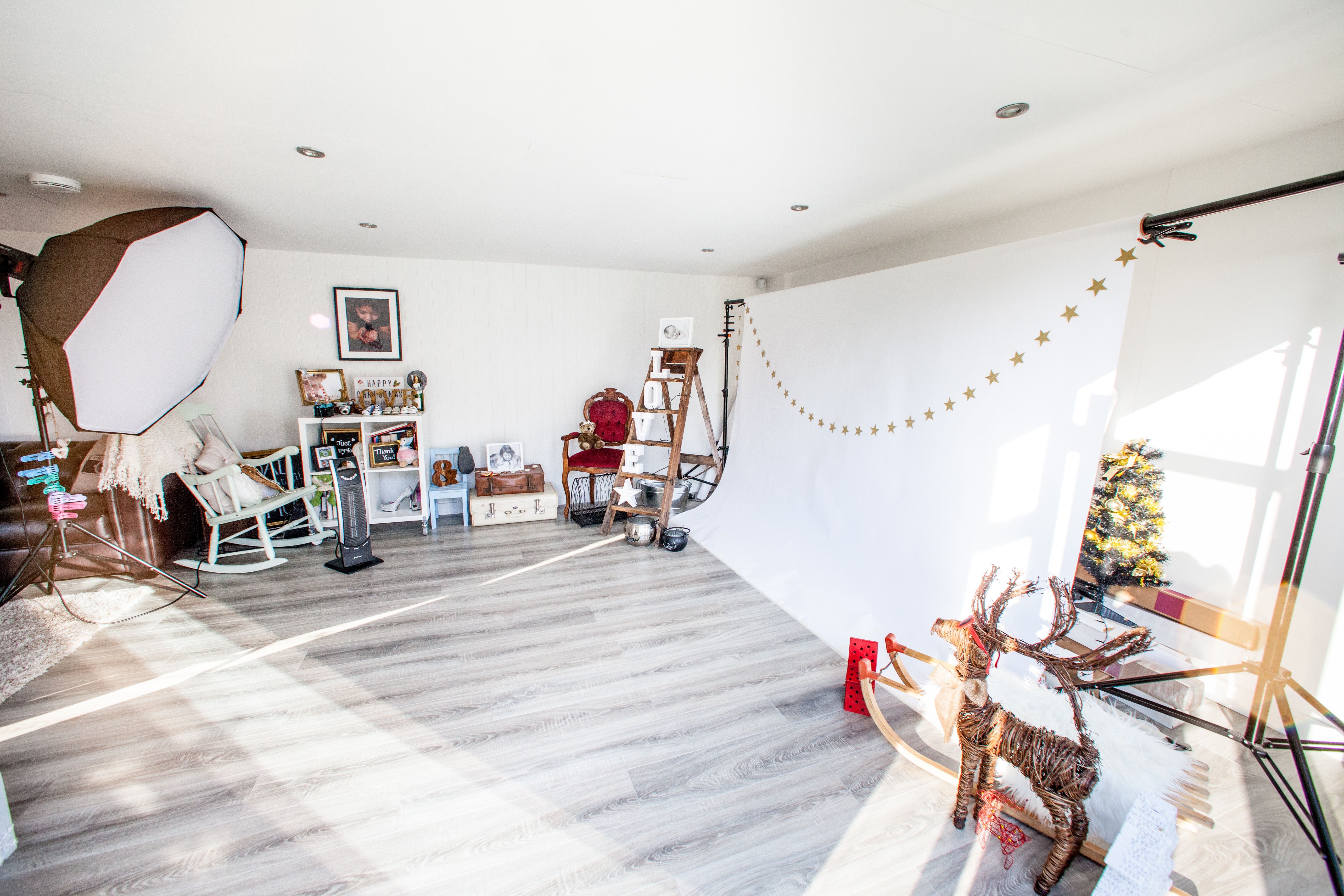 Interior of a Photography Studio in Garden with backdrop, lighting and props
