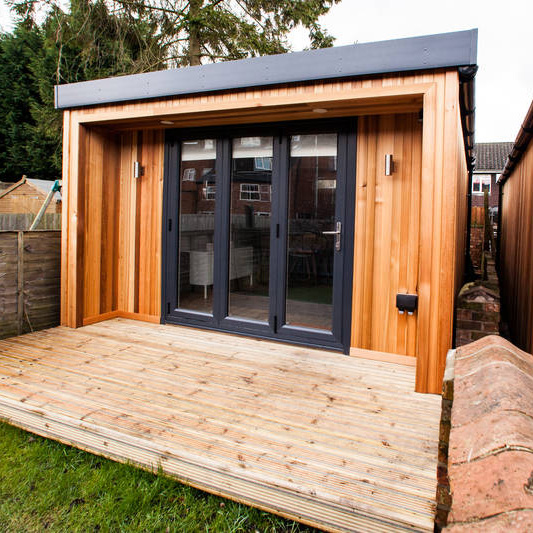 Cabin Master Cedar Small Garden Office Pod with timber decking and grass lawn in foreground