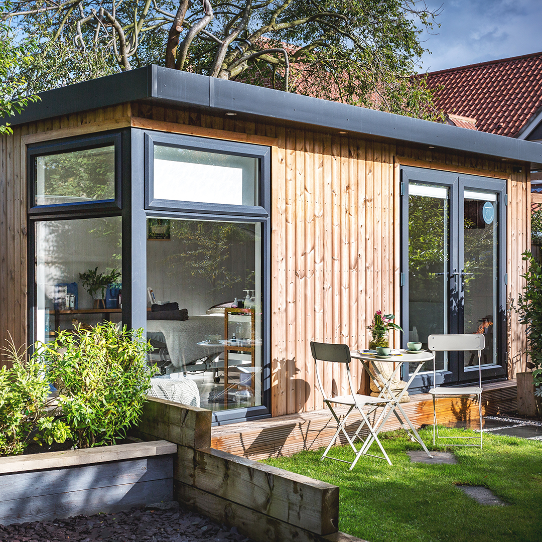 Exterior of a beauty garden room with bistro table setup outside