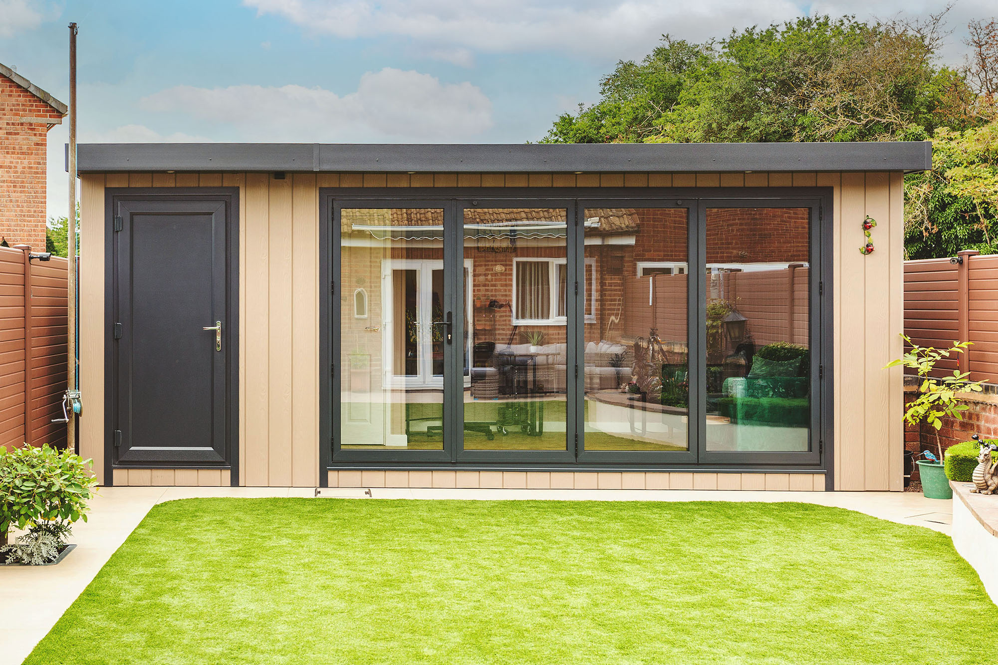 Zero maintenance garden office shed with cupboard and bifolds