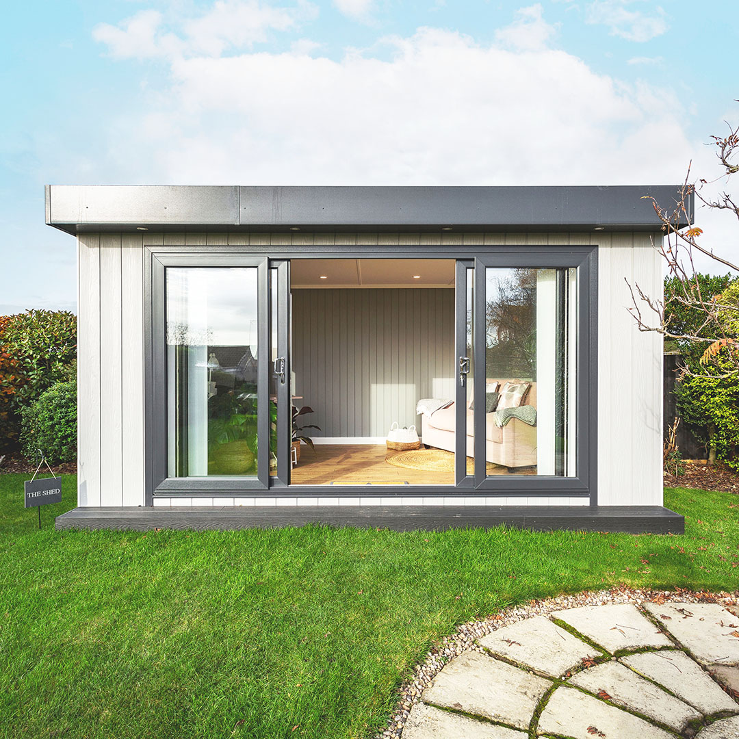 Looking into a bespoke garden office, desk and laptop can be seen