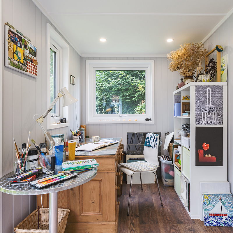 Interior of a garden artists studio with desk & shelving