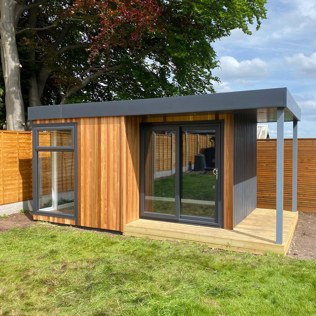 Cabin Master Cedar Garden Room with Veranda and grass lawn area in foreground