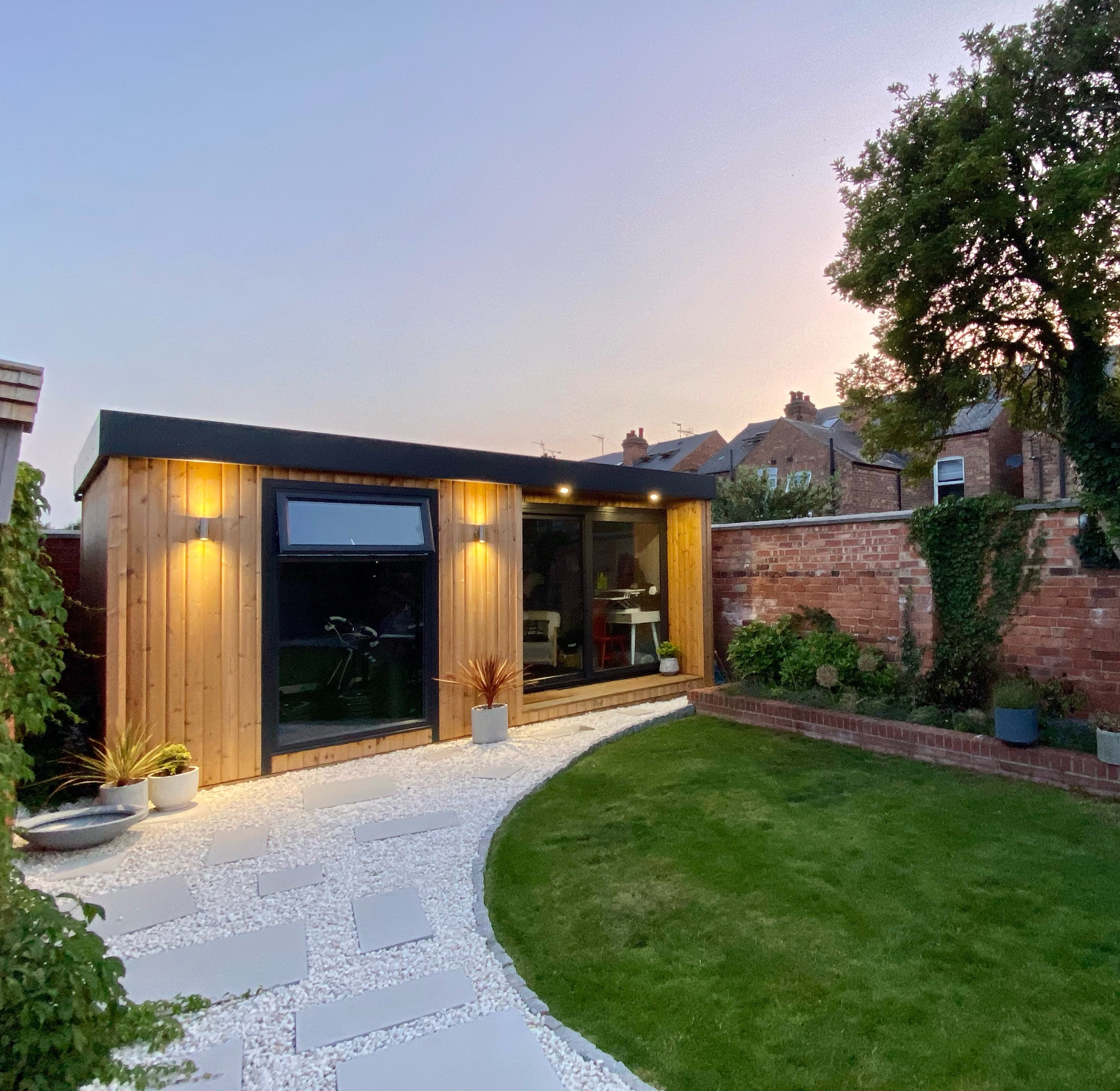 garden room small home office and gym with patio walkway and large lawn area 