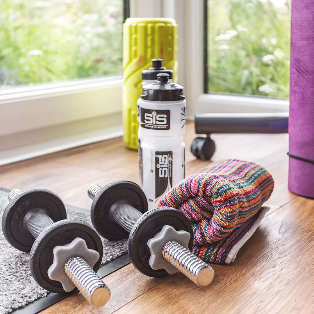 Cabin Master cedar home gym workout room garden building with equipment close up view water bottle towel and hand weights 