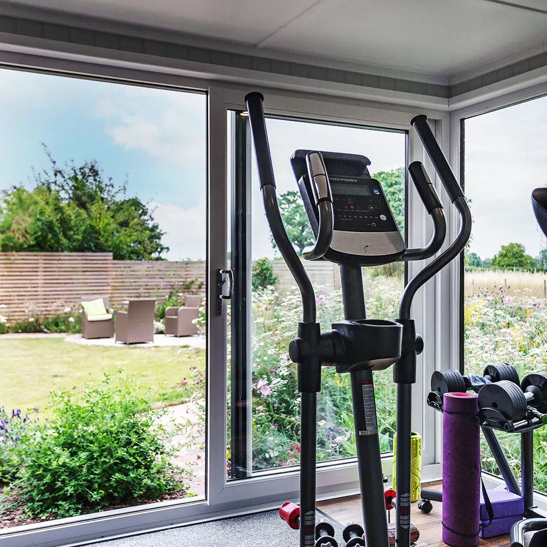 Cabin Master cedar home gym workout room garden building with view of garden and pathway and elliptical machine