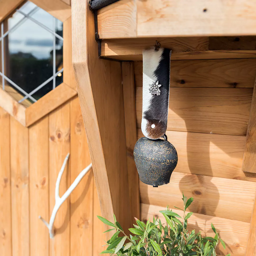 External close up shot of a BBQ grill house with cow bell hanging decoration