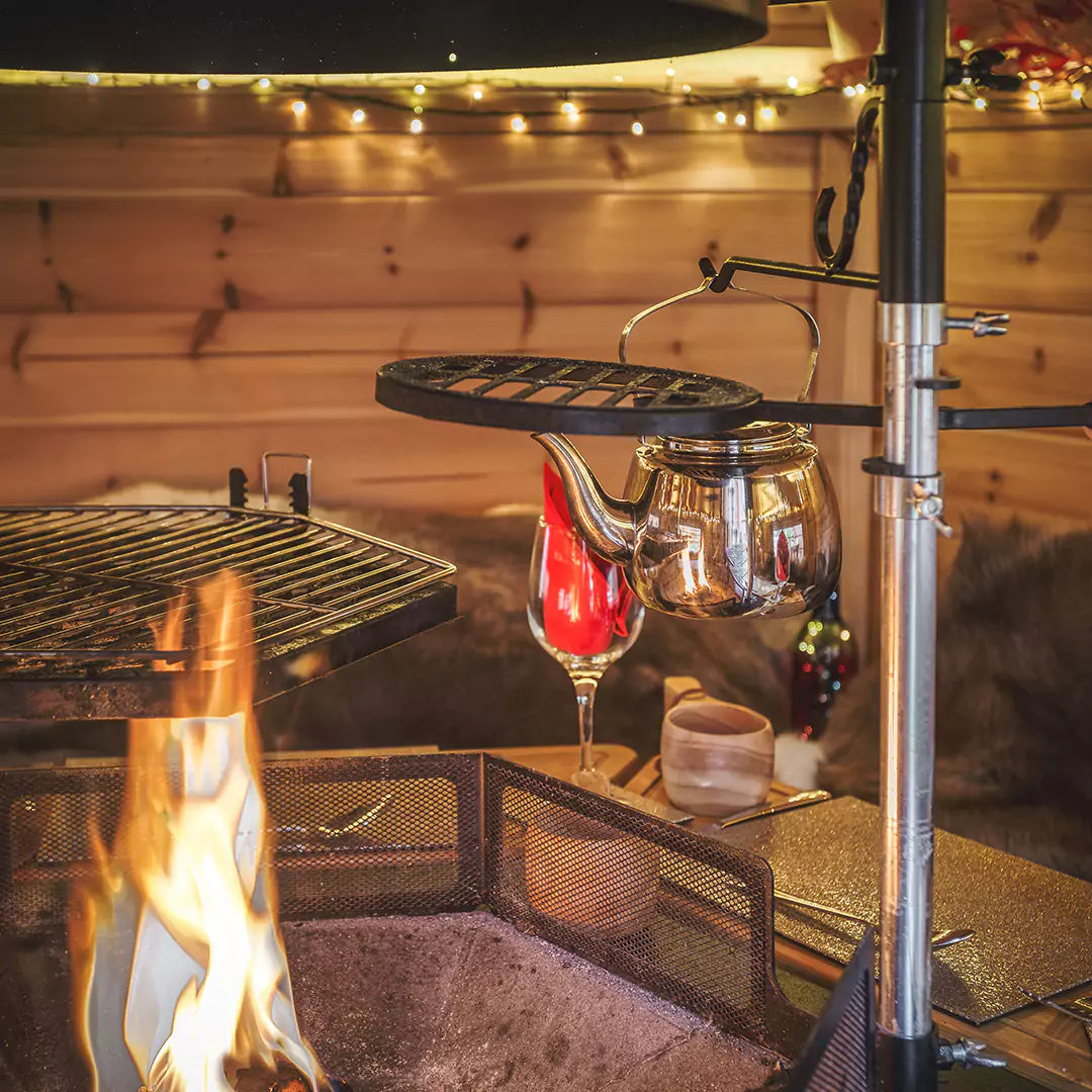 Interior of a small bbq cabin with fire lit & autumnal lighting