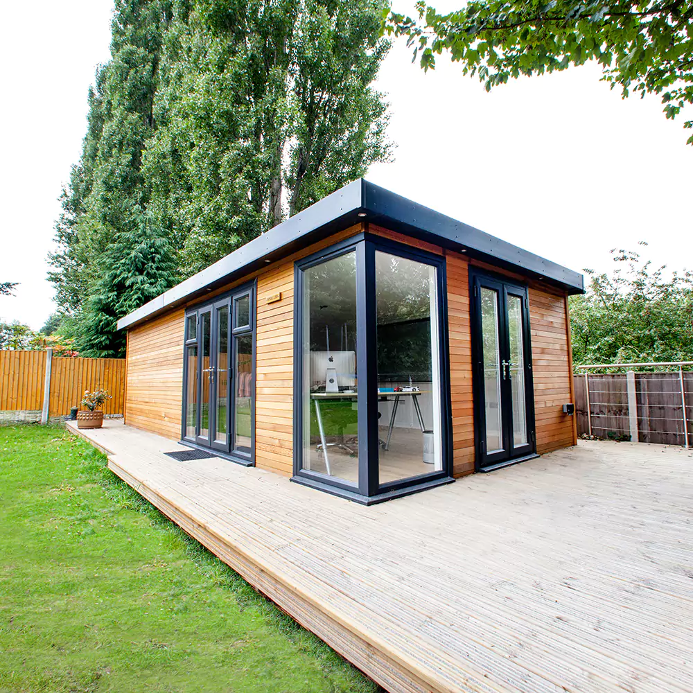 a wooden deck with a small timber garden cinema room on top of it