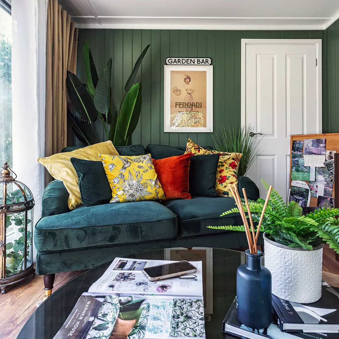 Inside a garden summer house with dark green decor