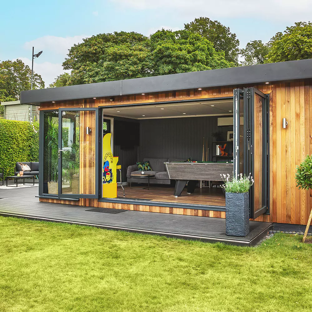 External shot of a cedar garden bar with sliding doors, on decking