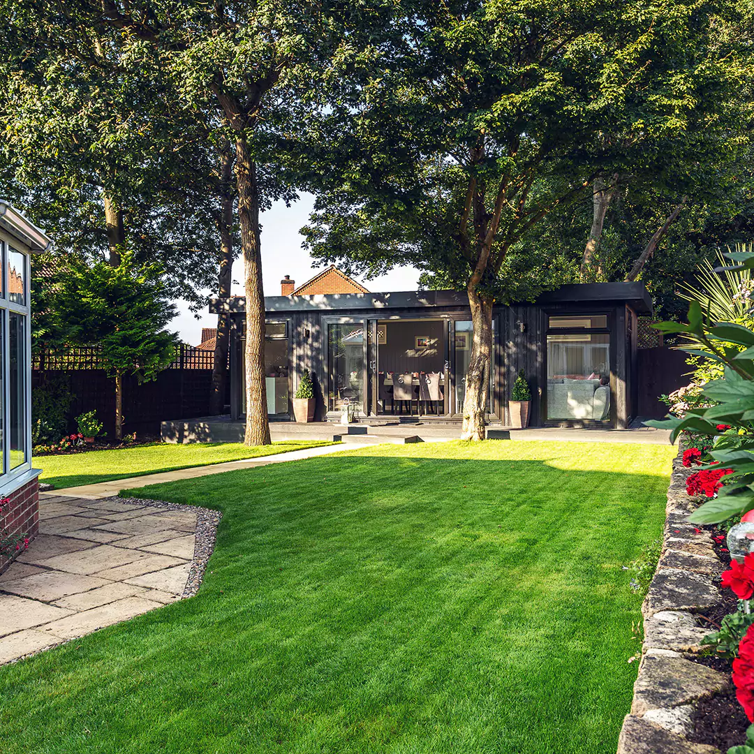 Black marley board garden room in large garden