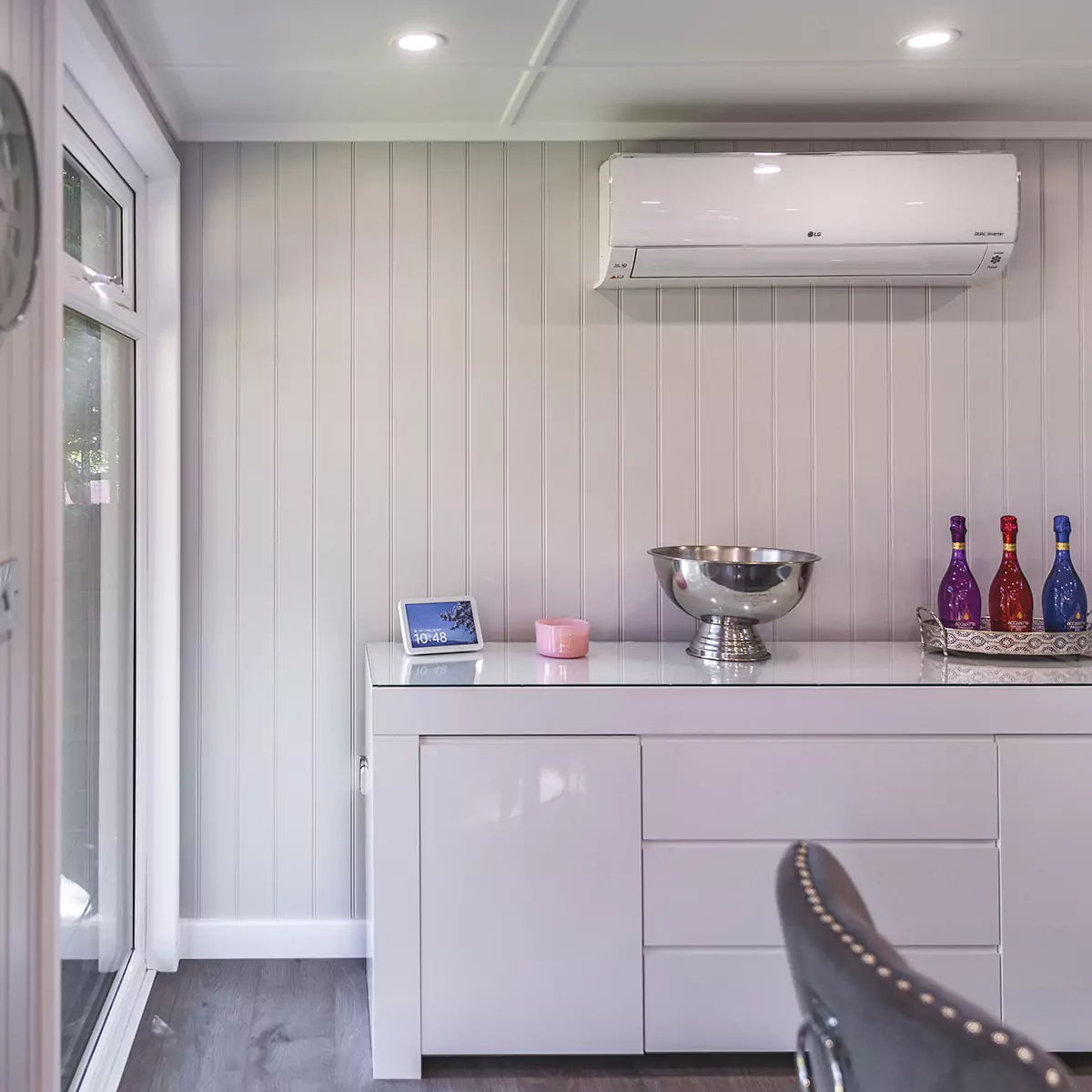 a garden dining room with a white counter top and white cabinets and AC unit