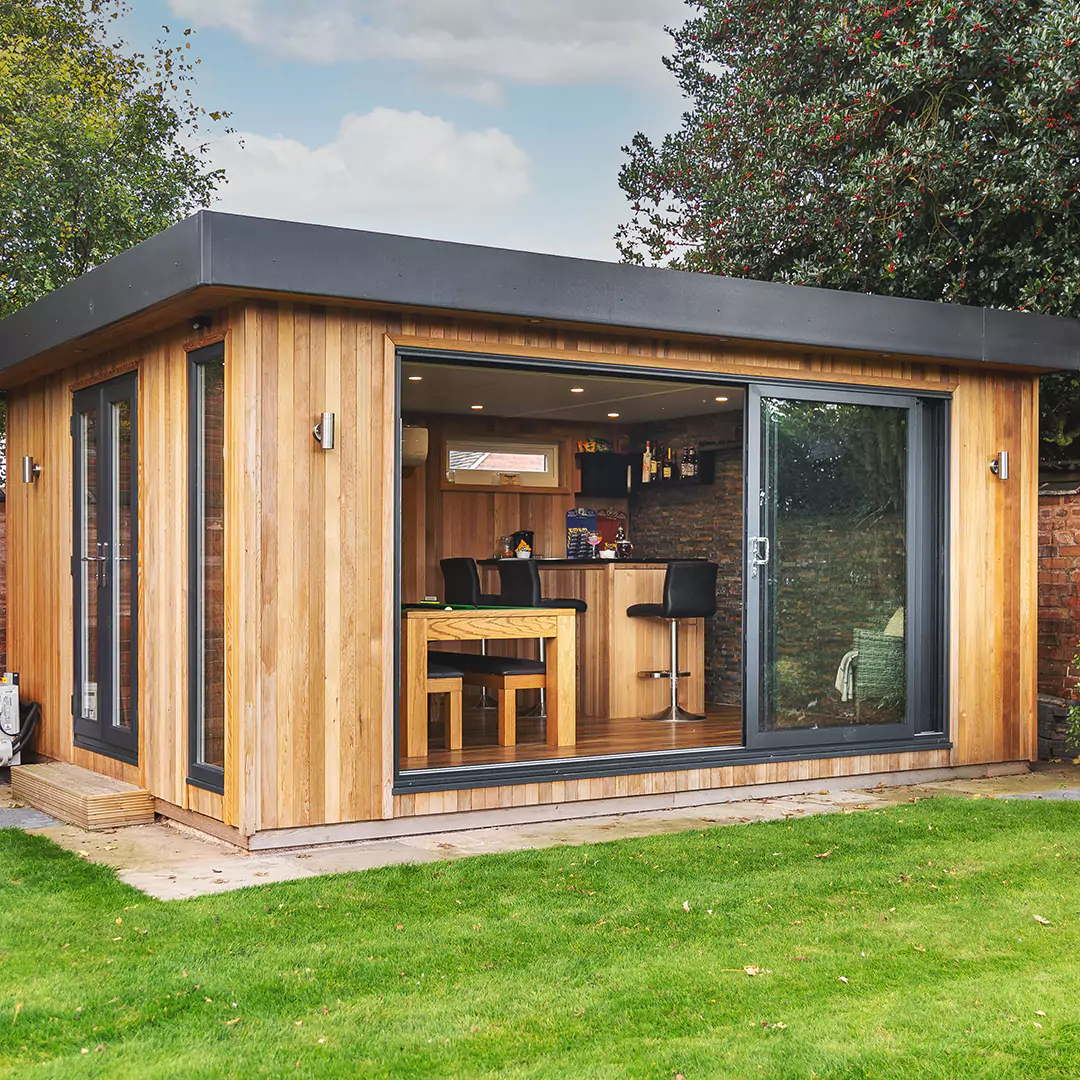 a small timber man cave garden building with black doors and windows 