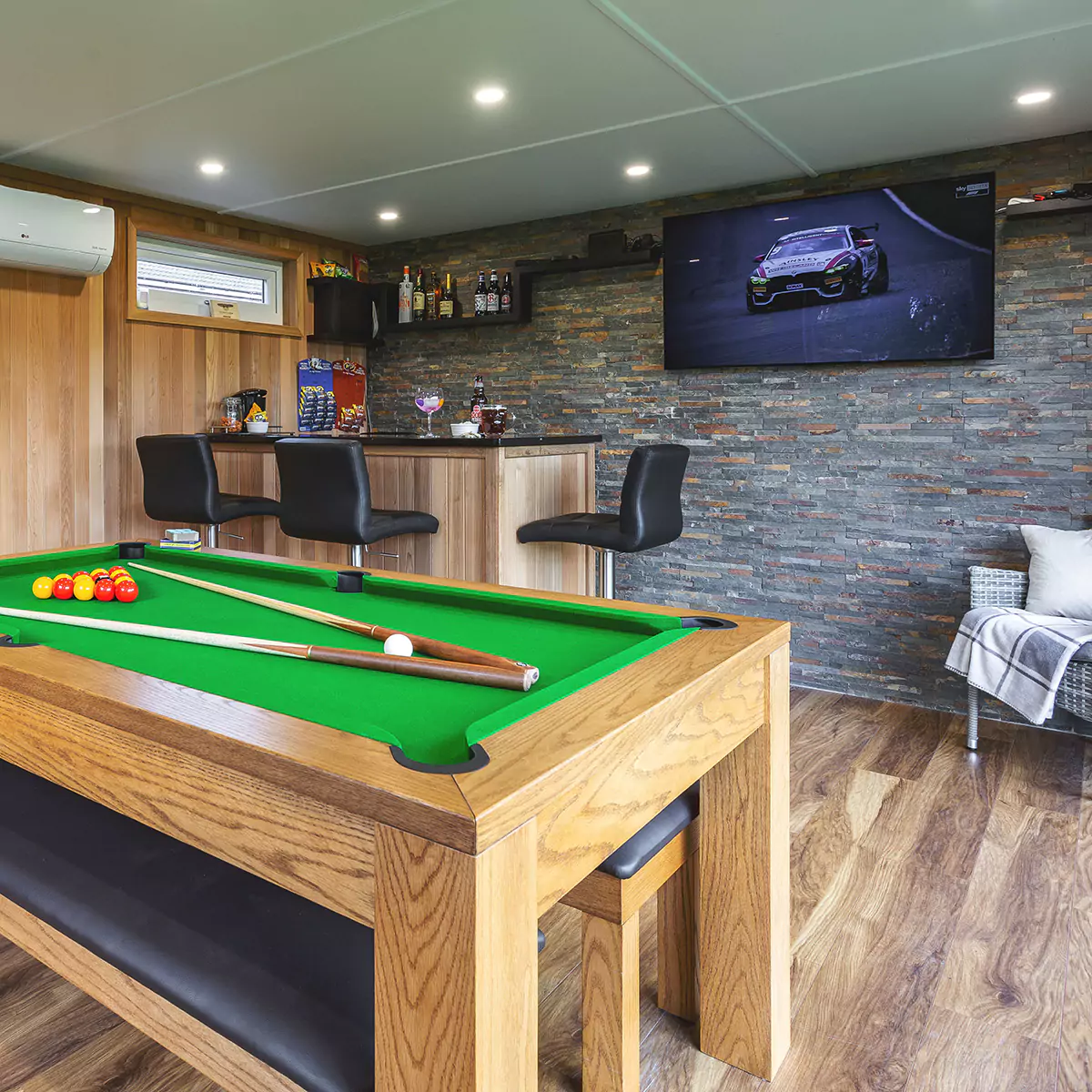 garden room man cave with a pool table and large flat screen tv
