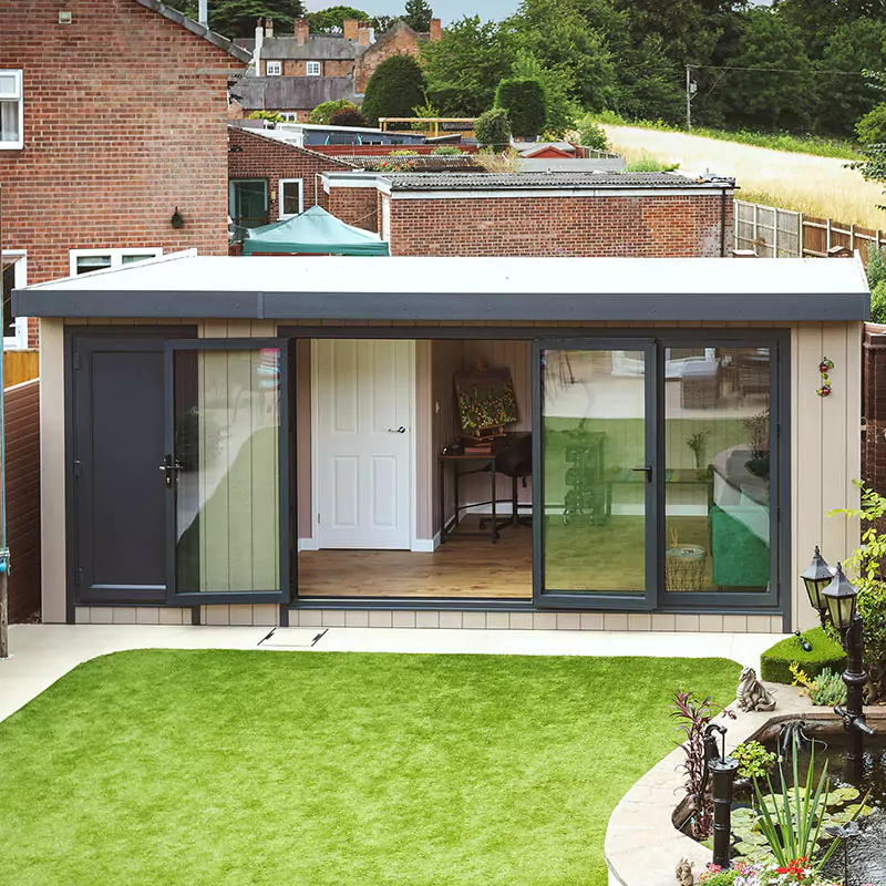 external view of cabin master garden room with view of large lawn area and patio with flower beds