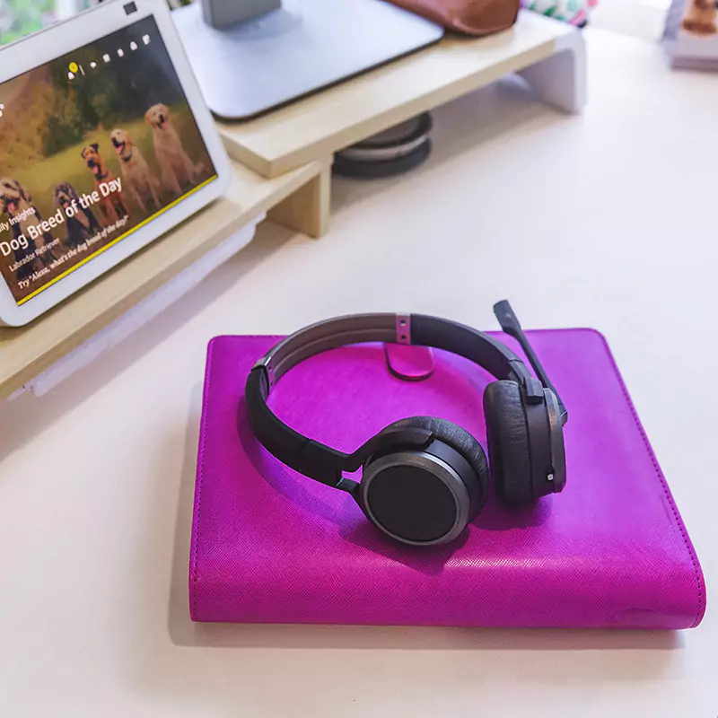 close up of headphones on top of notebook inside garden office