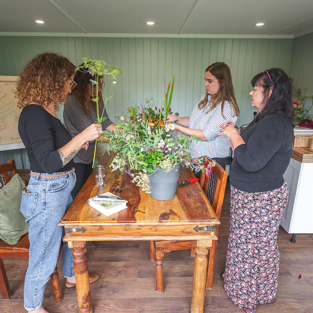 Interior of a garden studio with a floristry workshop taking place