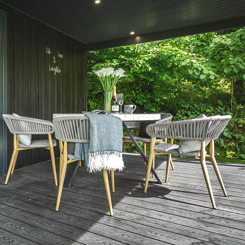 outdoor seating area under veranda of a garden room