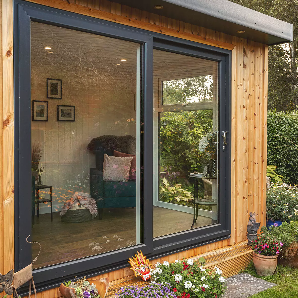 small garden summerhouse in outdoor area surrounded by potted plants