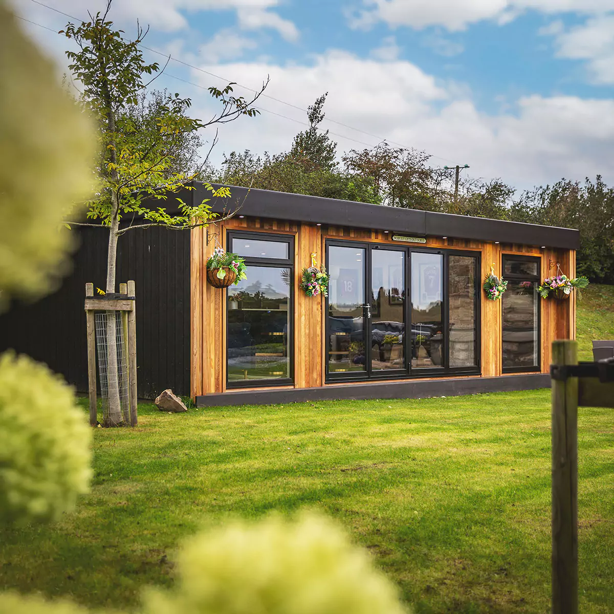 Looking inside a large luxury garden bar with bifold doors