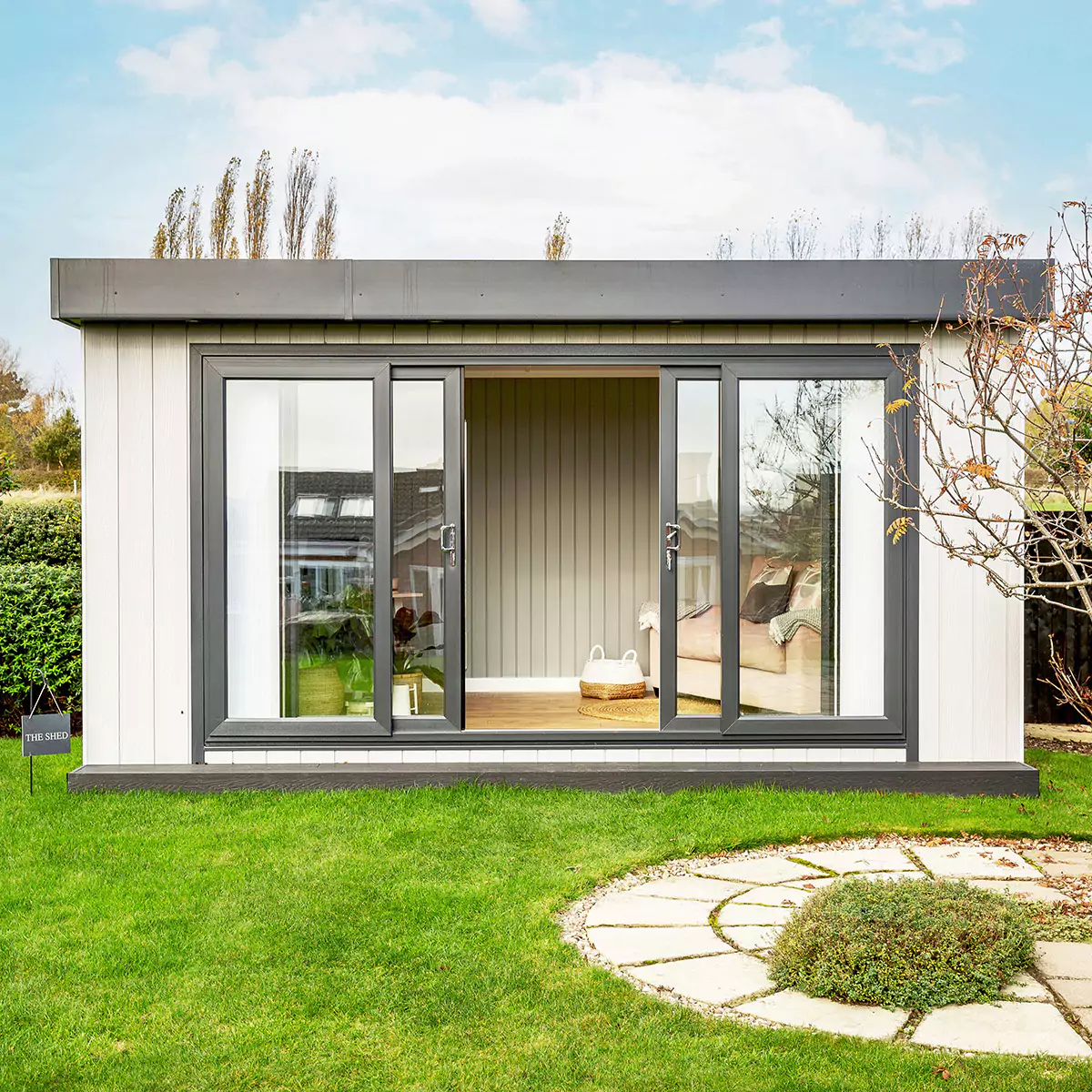 small marley garden office space with garden path and lawn area with sliding glass doors 