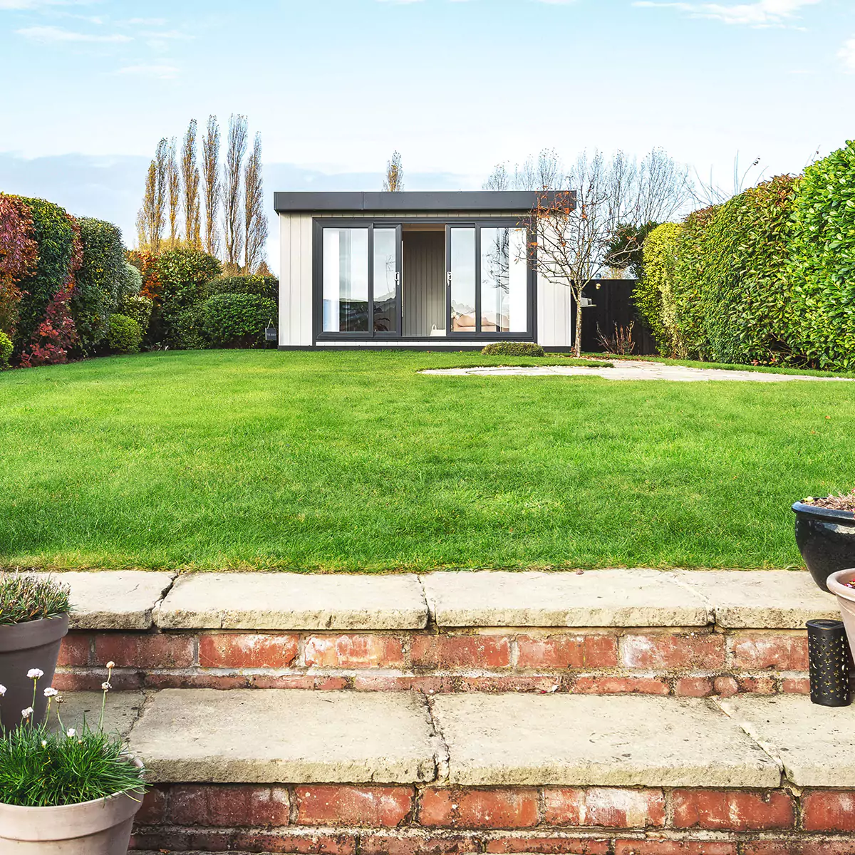 Zero maintenance garden office with black sliding doors